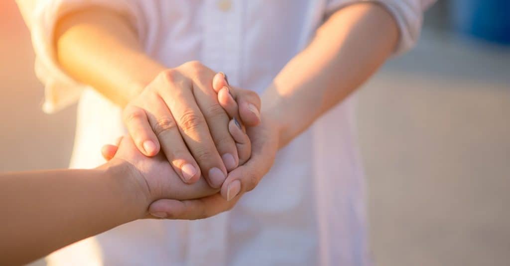 Man and woman holding hands closeup