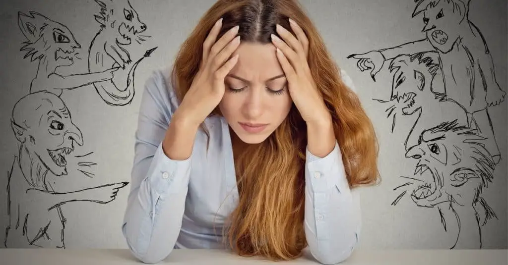 evil men pointing at stressed woman