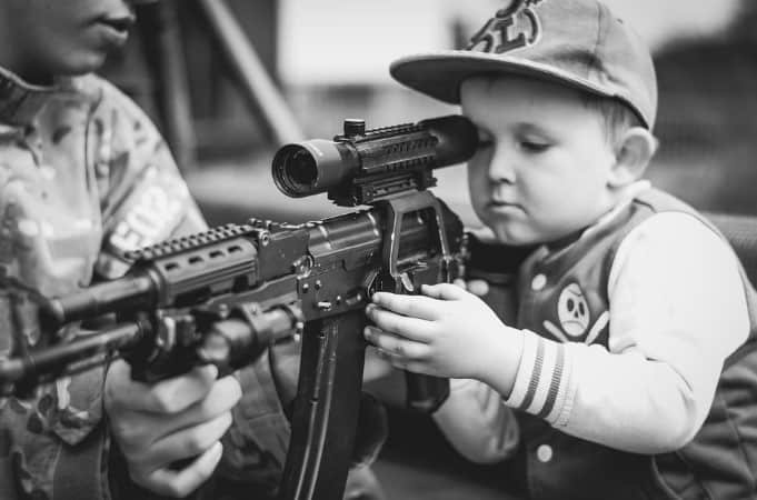 child on toy gun