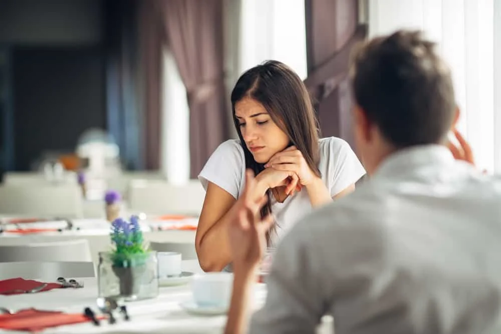 depressed woman being verbally attacked