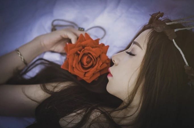 girl with rose in bed