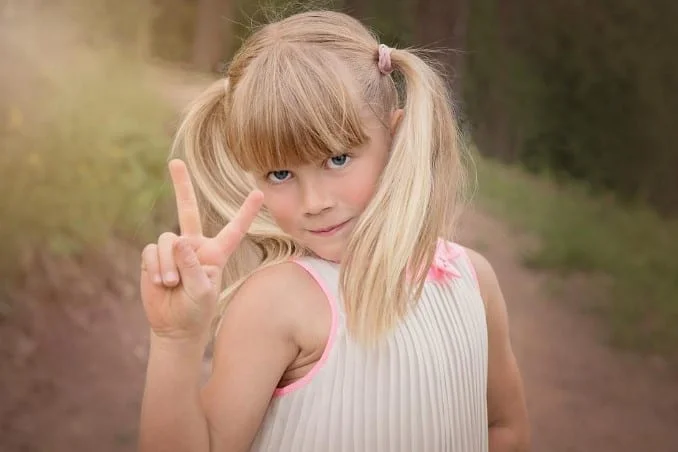 kid showing victory sign