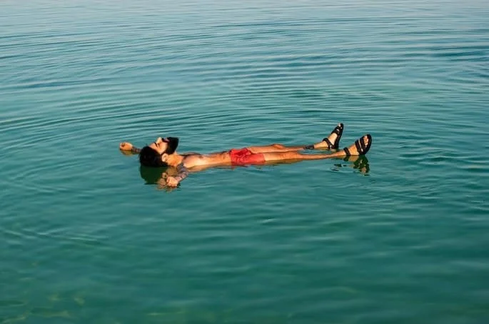 man relaxing in lake