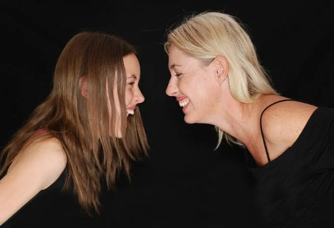 mother and daughter laughing at joke