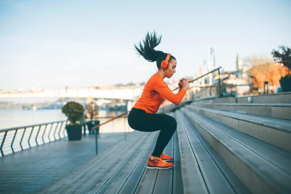 exercise habits 
woman jumping outdoor in urban environment