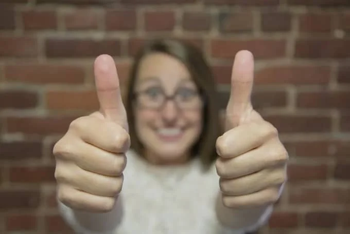 women showing thumbs up