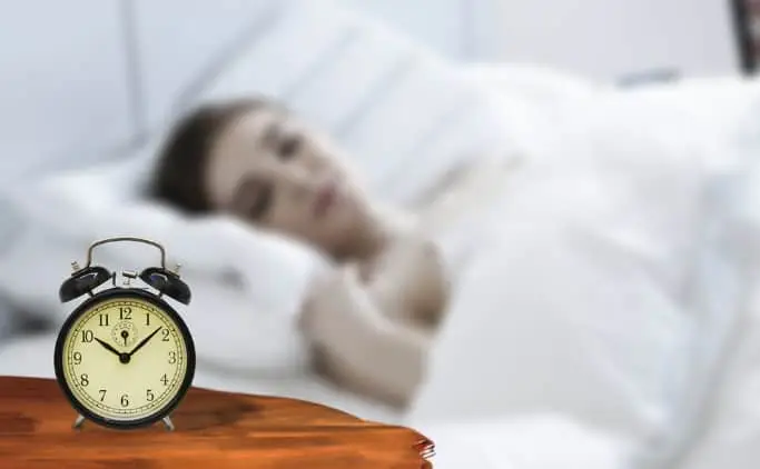 women sleeping with alarm clock