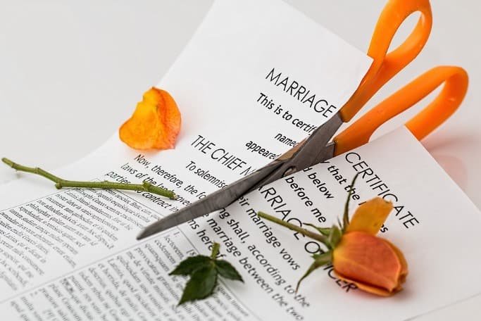cutting marriage certificate with scissor