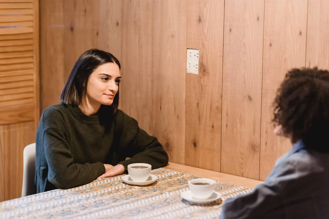 best friends talking in a cafe while drinking coffee