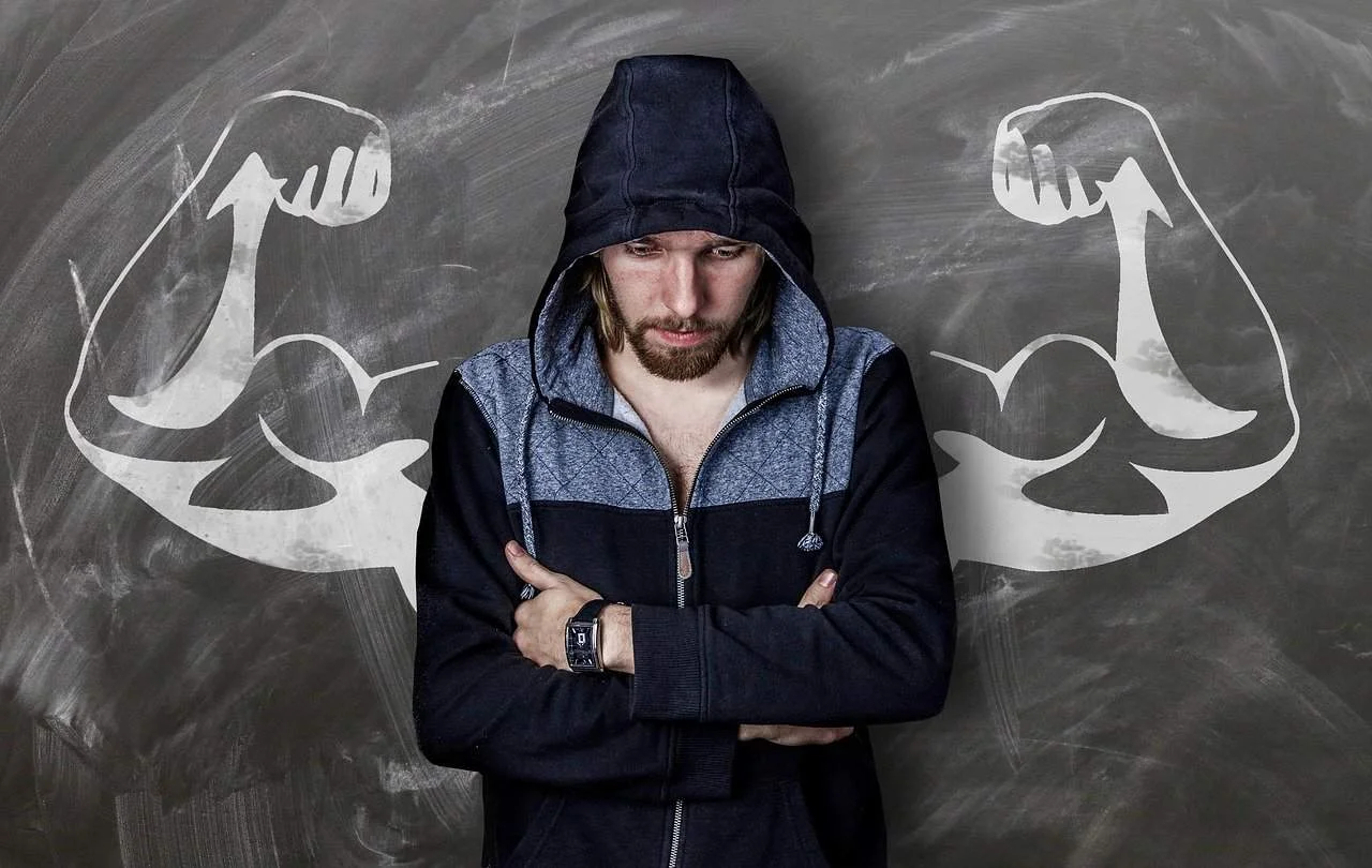 sad man standing in front of board drawing