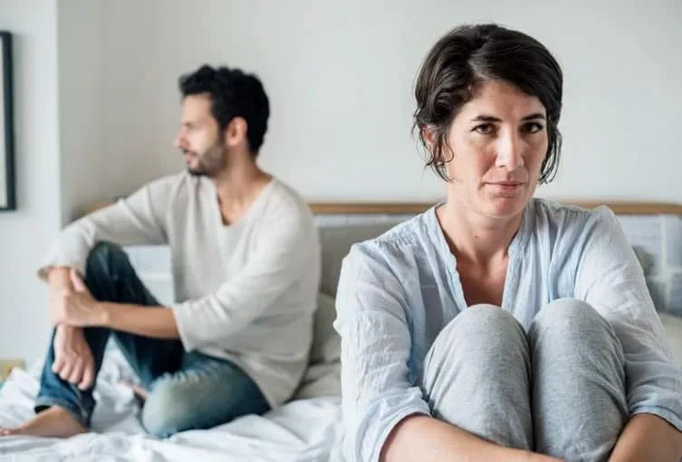 couple in bed having an argument