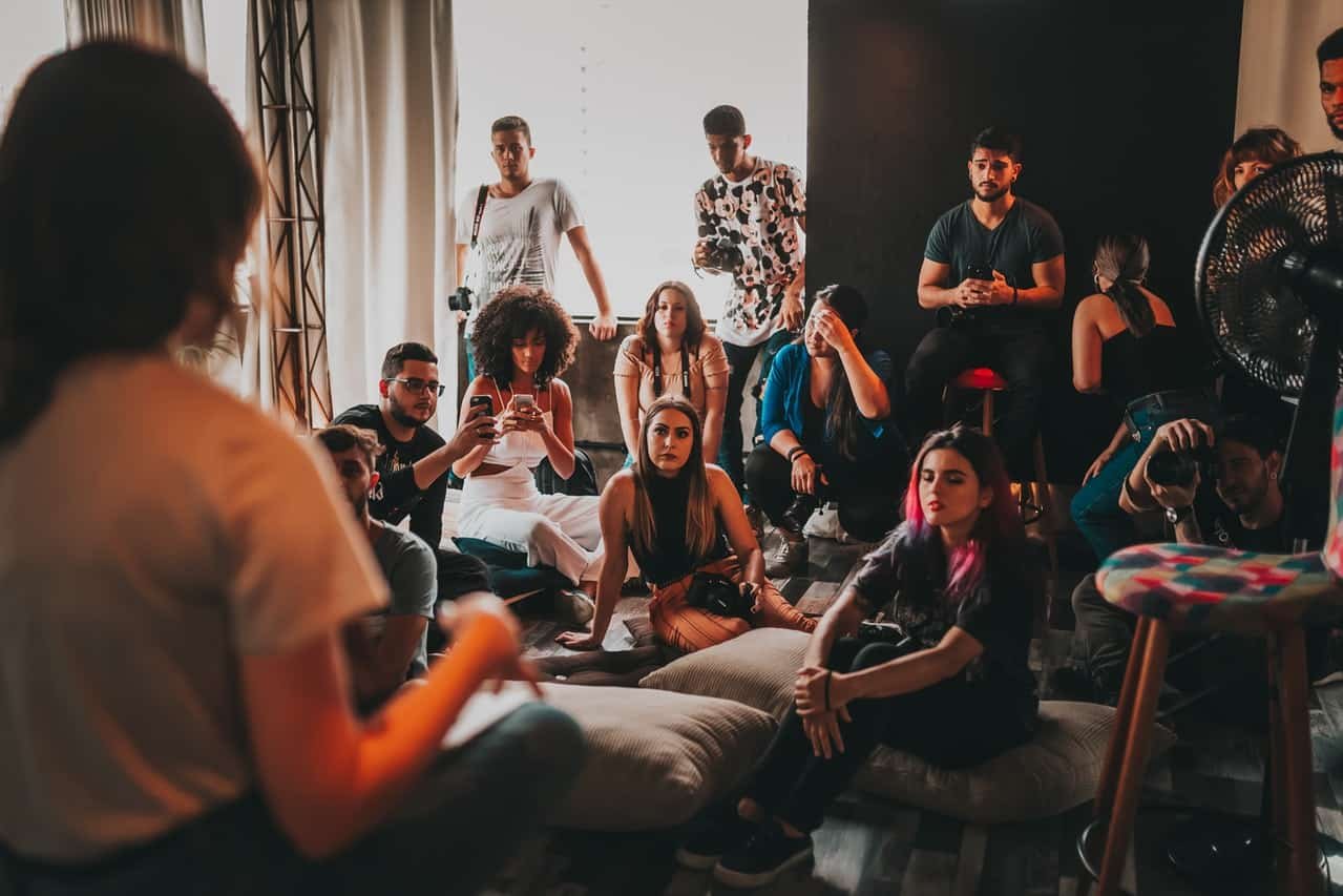 female speaker talking to the group of people in studio