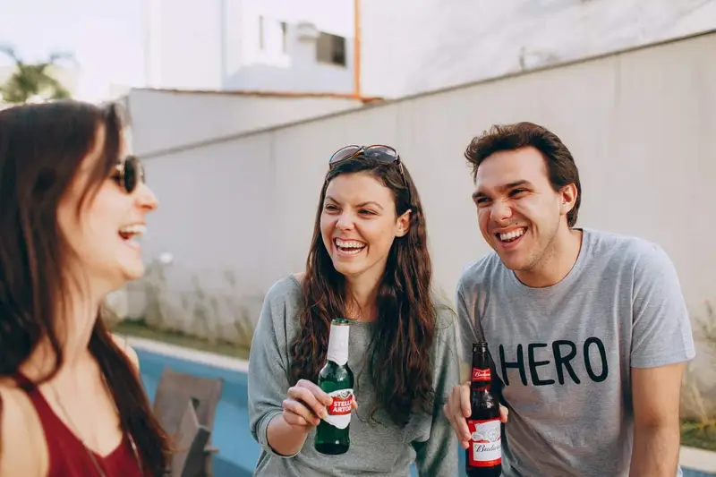 group of happy friends drinking bear outdoor