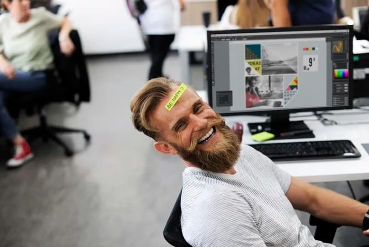happy bearded man in office