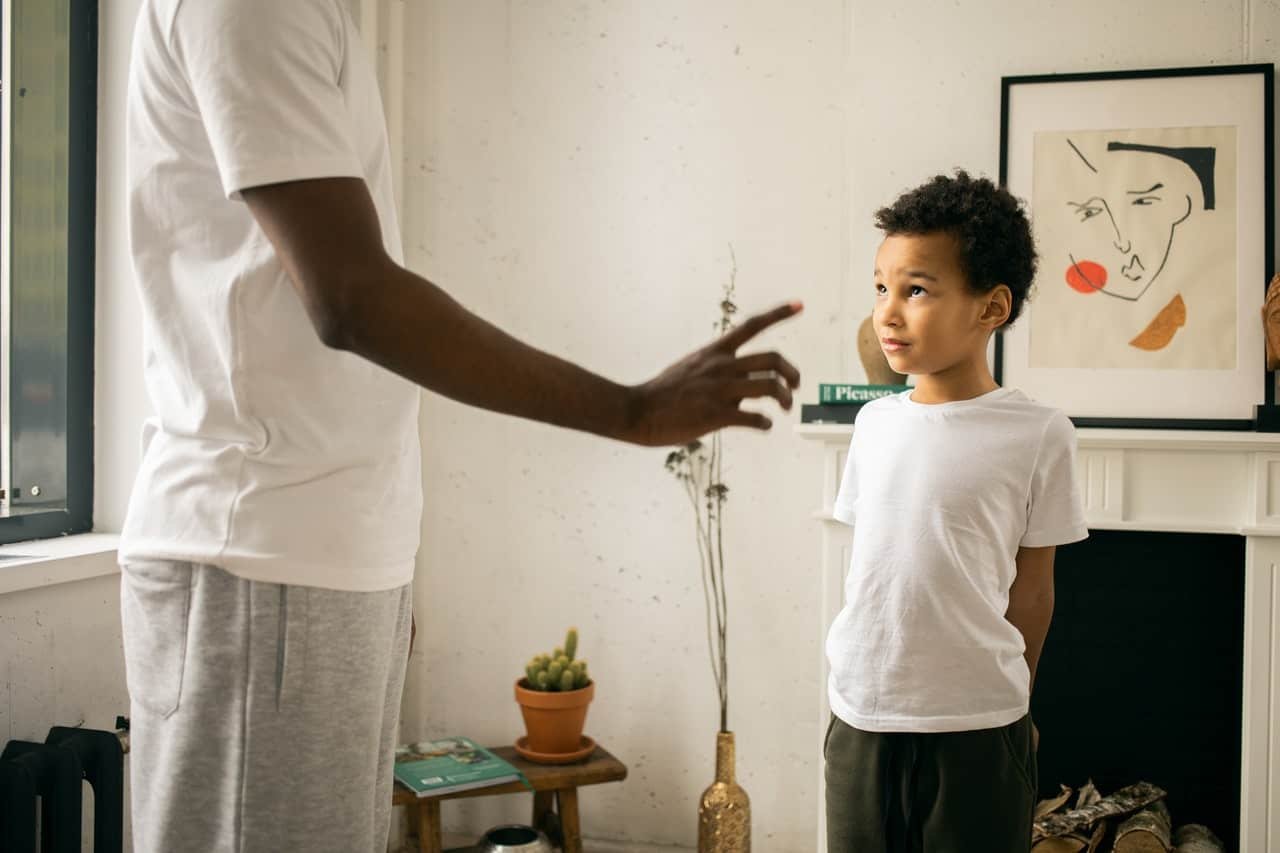 father scolding son in home