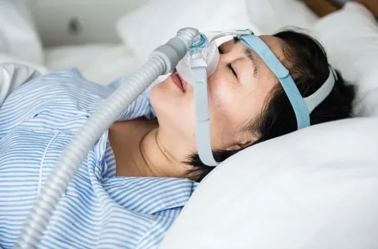 sleeping woman wearing an anti-snoring device