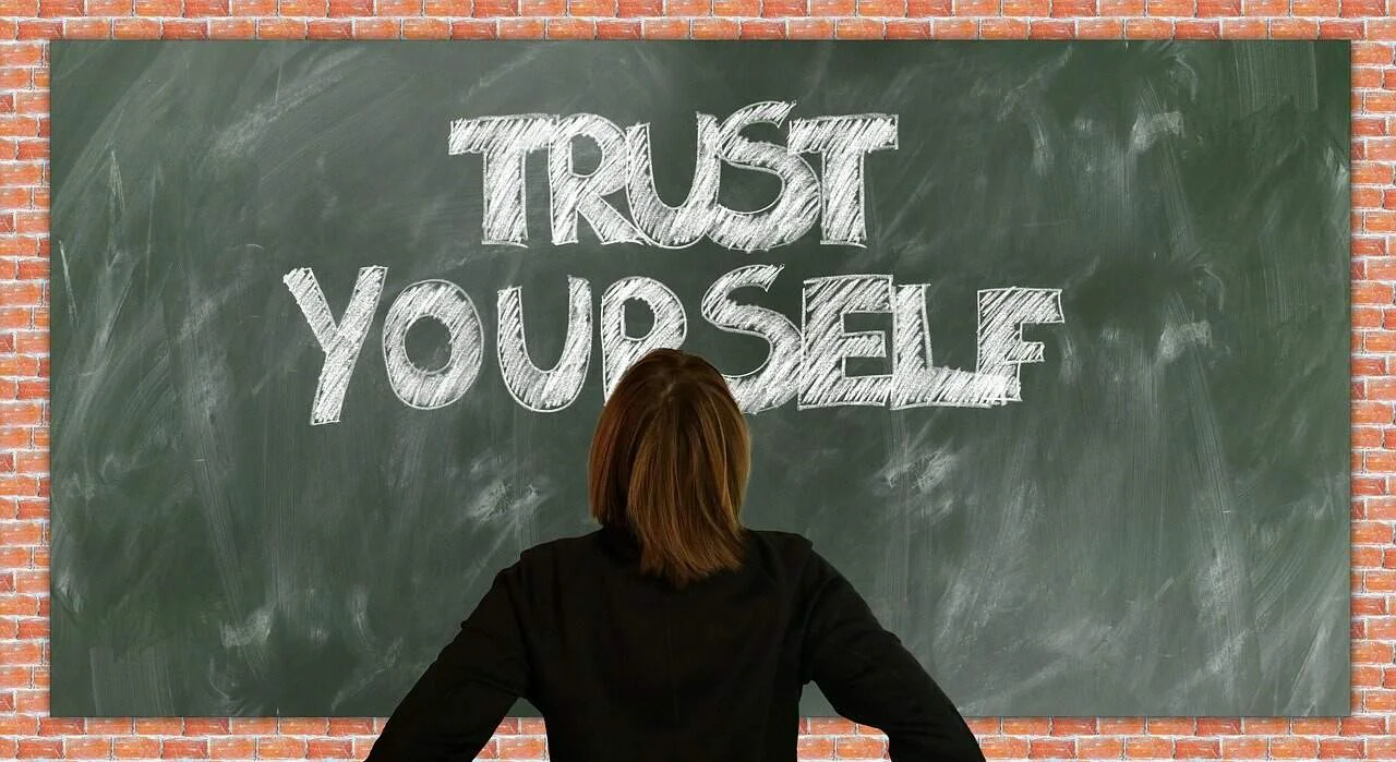 women looking to trust yourself text written on blackboard