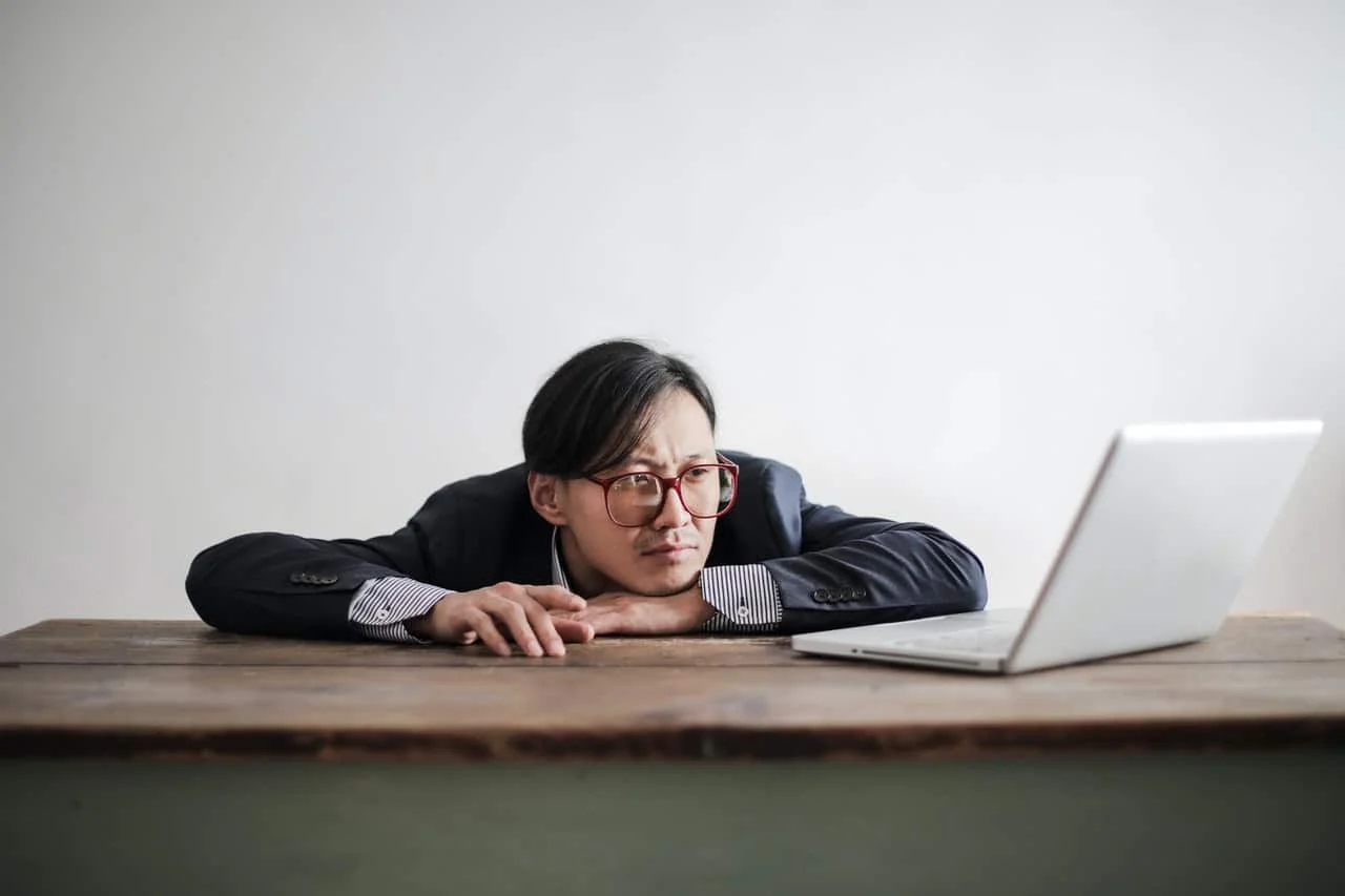 man watching laptop on his working desk