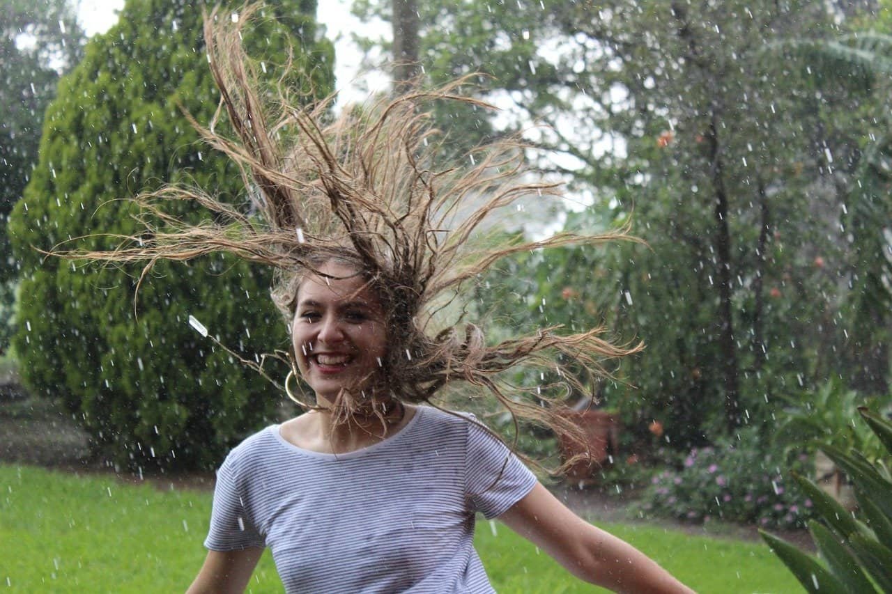 women happy in rain