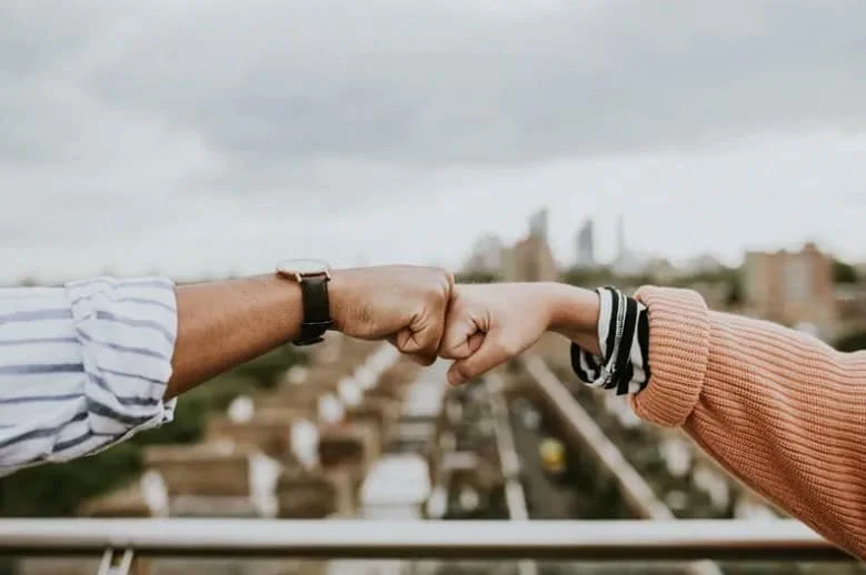 friends doing a fist bump