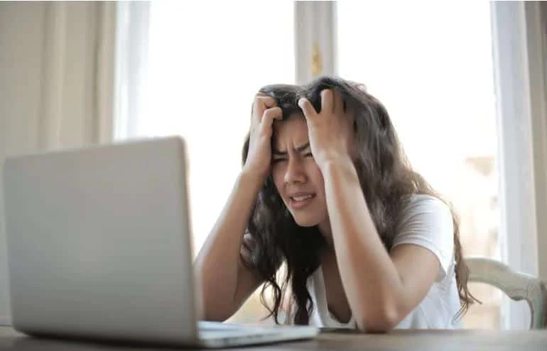 frustrated woman holding her head