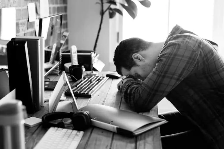 stressed man with head on the work table