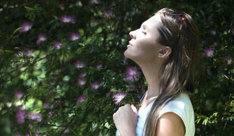 woman basking in the sunlight with eyes closed