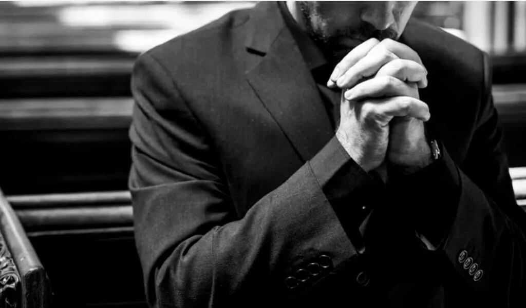 man praying in the church