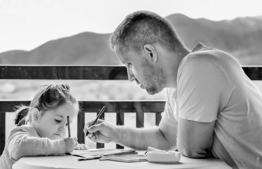 father and daughter doing homework