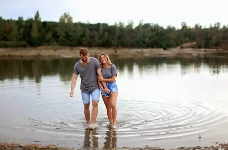 couple walking on pond water