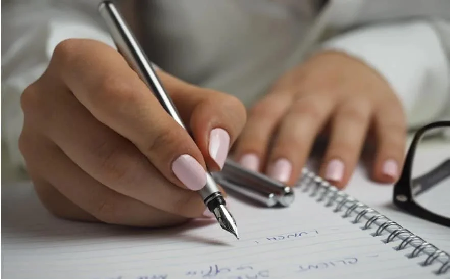 woman writing in a notebook