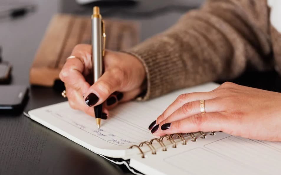 women writing a bullet journal