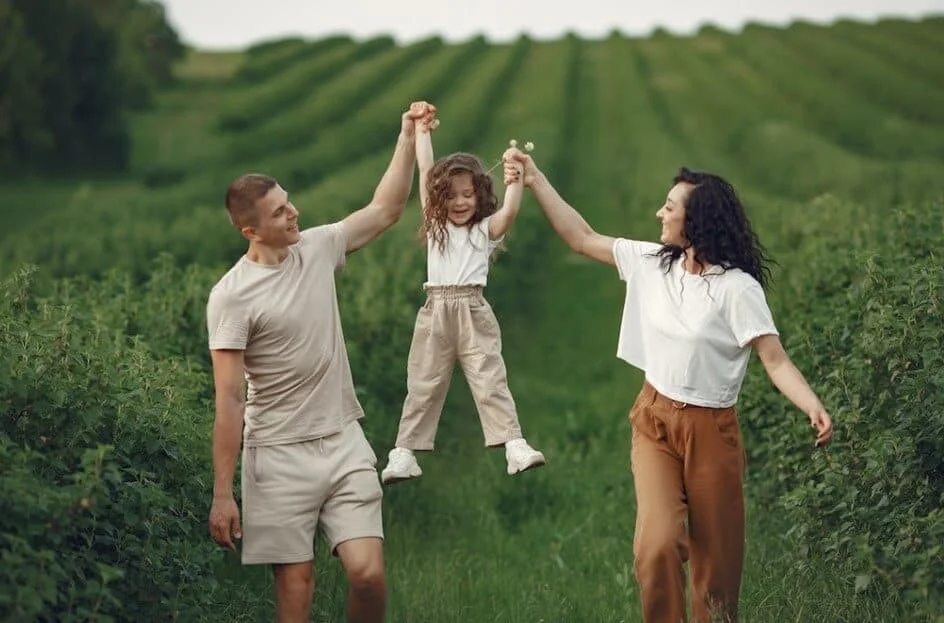 parents playing with little girl