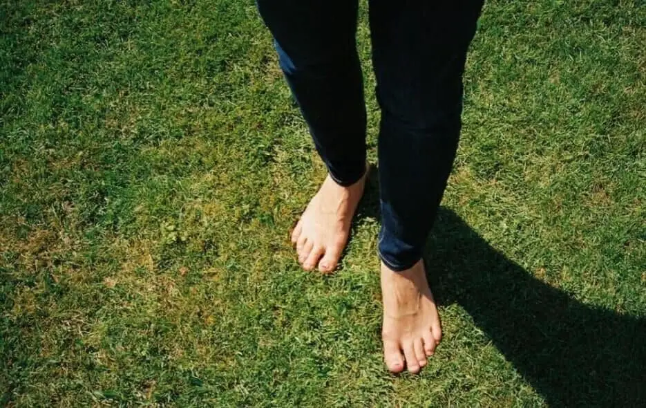 standing barefoot on grass