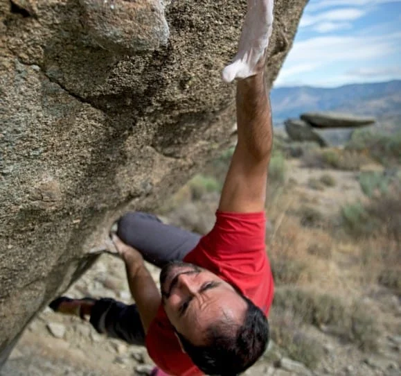 man climbing a rock