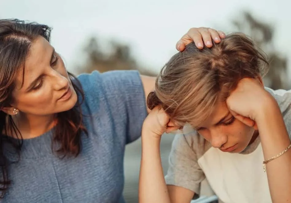 mother talking to young boy