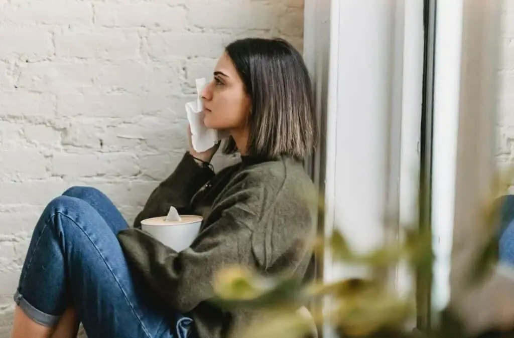 Woman crying near a windows