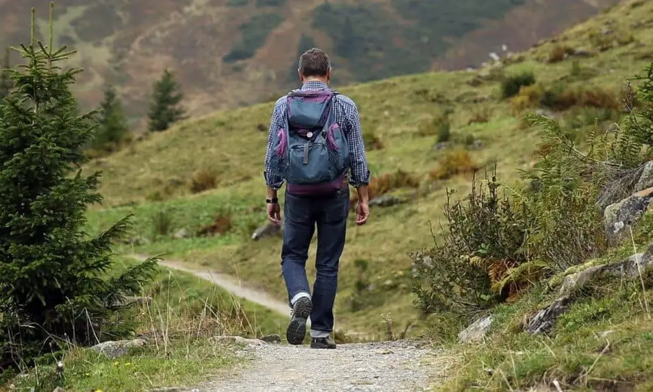 man walking along a trail