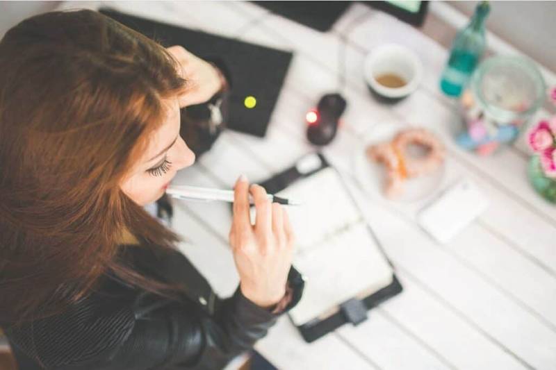 Woman at a desk thinking