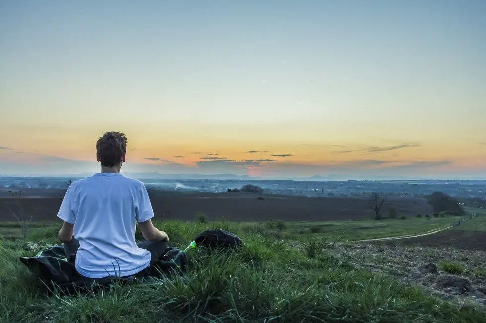 Man sitting in a meditative pose outdoors