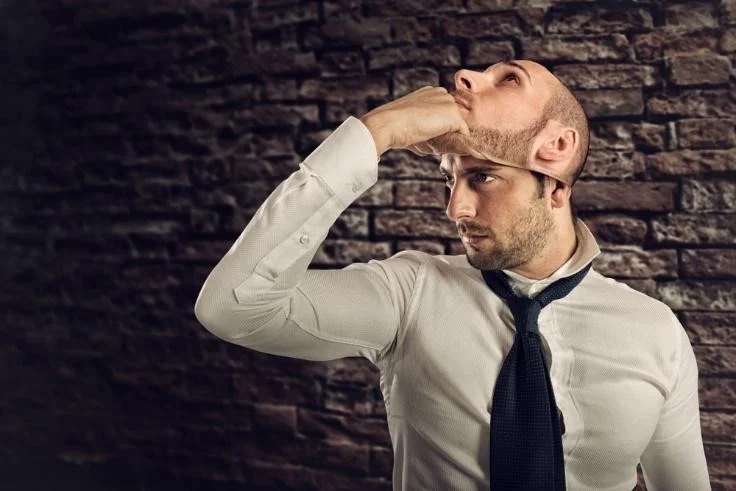 Man taking off a mask