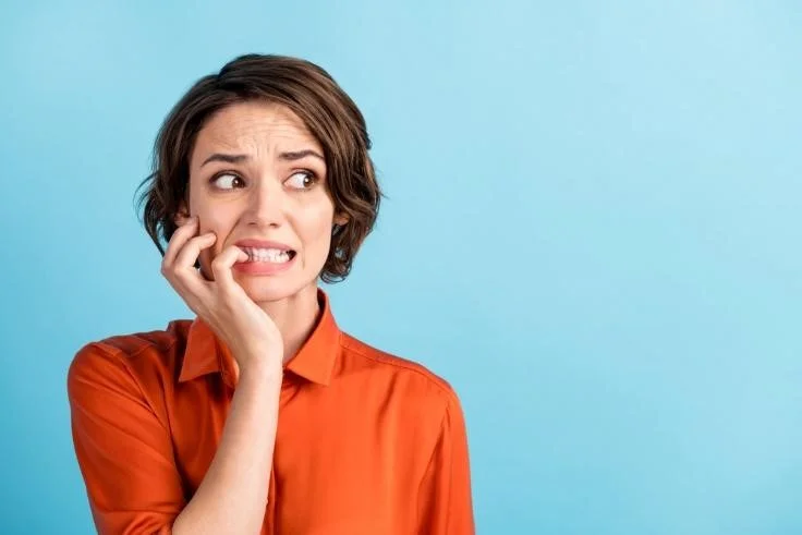 Nervous lady biting her nails