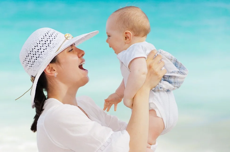 Happy mother playing with her baby